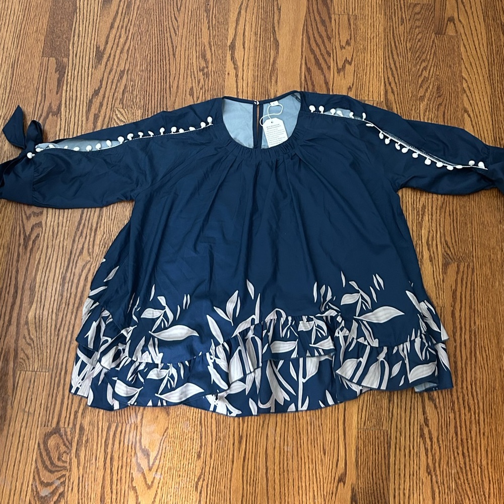 Navy Blue “cold shoulder” Blouse with White and tan floral Pattern. NWT size L